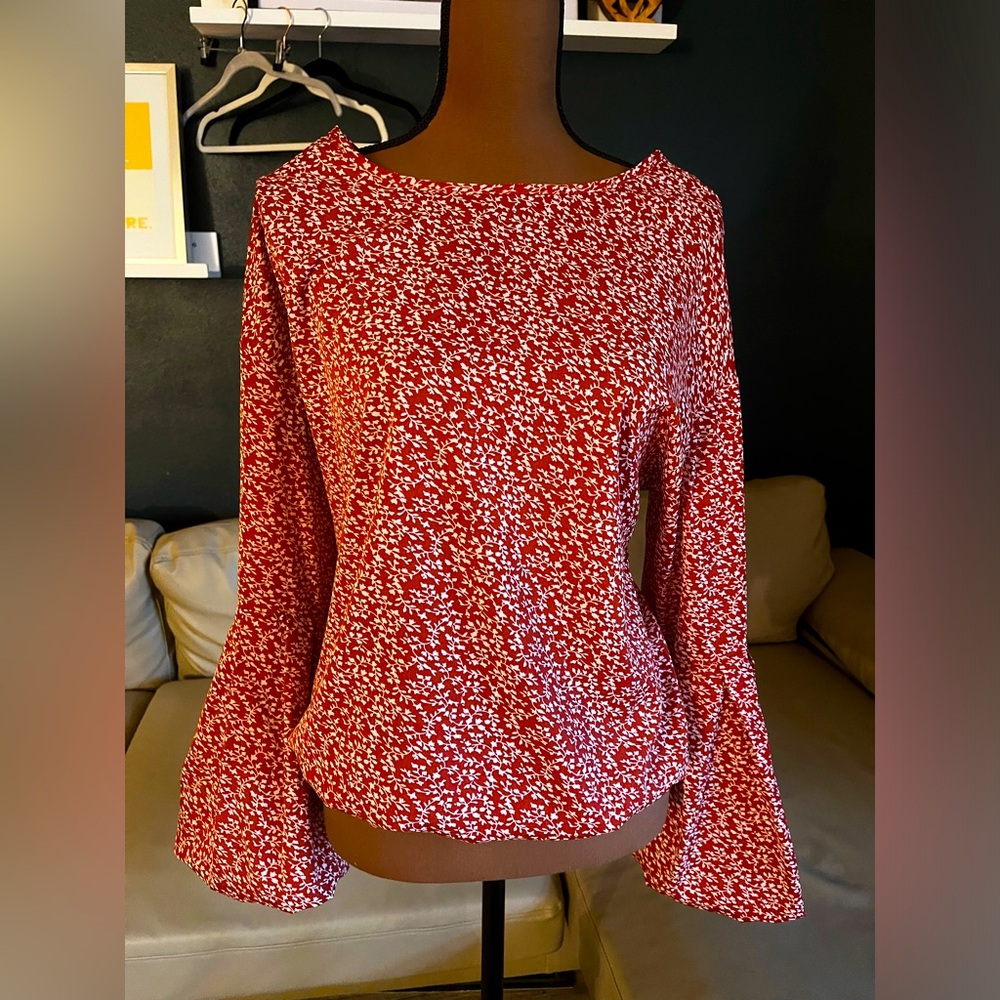 Ditsy floral blouse with bell sleeves.